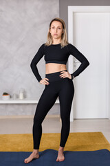Tired Woman feeling Exhausted after Exercising in Sportswear on Yoga Mat in Living Room, Getting Fit at Home Concept, Copy Space