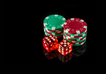 Poker dice on black background and chips. Craps club game concept
