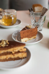 Desserts stand on the table on the background of the cafe