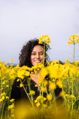 portrait of a girl in springtime in a field of yellow flowers