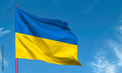 National flag of Ukraine or Ukrainian flag against blue sky