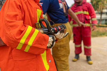 Firemen were helping to carry water hoses in preparation for the fire.