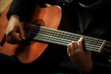 Fototapeta premium child playing guitar close up