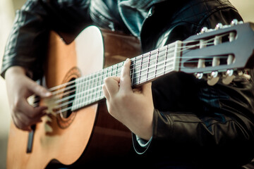 Fototapeta na wymiar child playing guitar close up