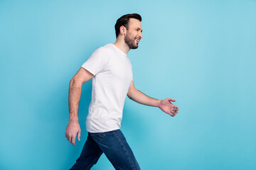 Profile side view portrait of attractive cheerful guy specialist going fast career promotion isolated over blue pastel color background