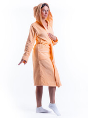 woman in a Bathrobe on an isolated white background with a smile on her face.