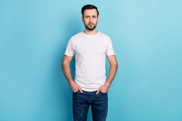 Portrait of attractive content guy expert specialist holding hands in pockets isolated over blue bright pastel color background