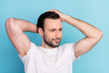 Close-up portrait of attractive cheerful well-groomed guy caressing hair gel fix isolated over blue bright pastel color background