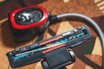 Cleaning the room, long hair wrapped around a vacuum cleaner's turbo brush