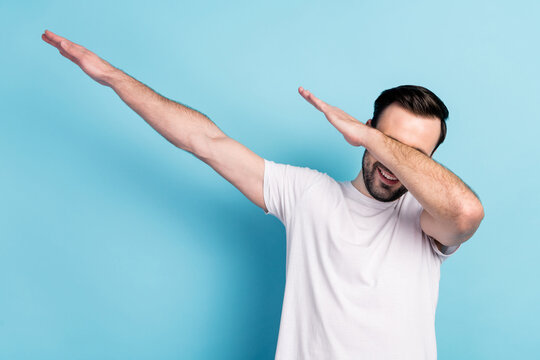 Portrait of attractive cheerful funky guy dancing having fun dab nightlife isolated over blue bright pastel color background