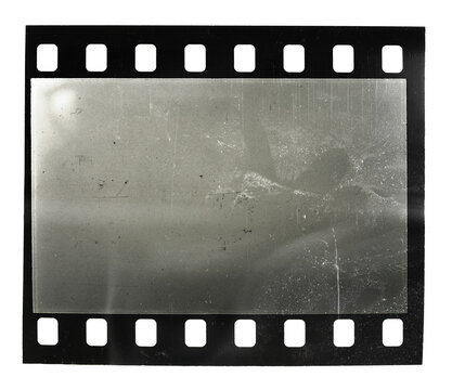 real macro photo of blank or empty 35mm film frame on white background with scratches and dust.