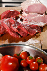 Raw fresh meat Ribeye steak entrecote pork and beef and seasonings on wooden cutting board.