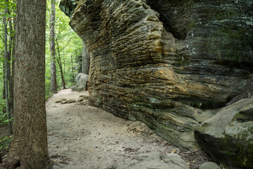 Sandy Trail Follows The Contour Of Overhanging Rock Wall