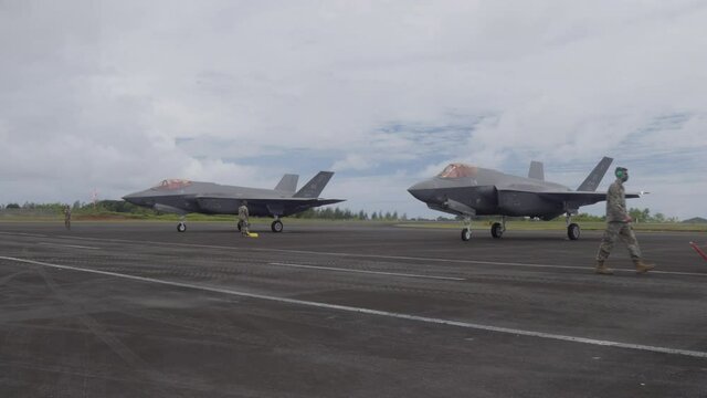 Two F-35 jet fighters sit on the tarmac after refuelling in Palau