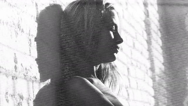 woman posing agaisnt brick wall glitching