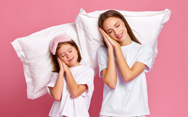 Mother and daughter sleeping on pillows