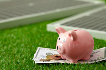 Solar panel model and piggy bank close up