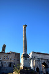 Fototapeta premium view to the roman forum - a column, Septimius Severus Arch, Senatorial Palace Capitoline Hill - Rome, Italy, Europe 