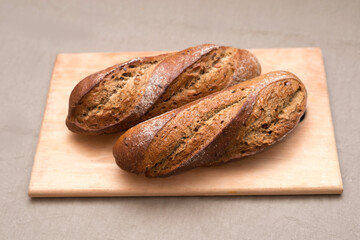 Dark bread on the table on a wooden cutting board
