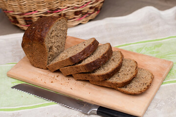 The bread is cut into pieces and lies on a wooden board on the table