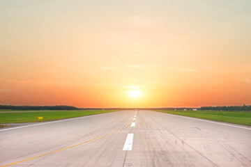 Empty runway with morning sunrise light firmament.