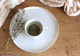 Floral composition with goat willow on old wooden table with silk plaid. Selective focus, blurred background. Place for your text.