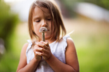 caucasian child girl with mushroom, natural products, mushrooms collected in the forest