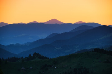 Fototapeta premium View of a mountains range. Landscape during sunset at the summer time. Foggy hills in the mountains ragion. Travel image. Spring landscape.