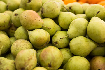 appetizing pears on counter in market
