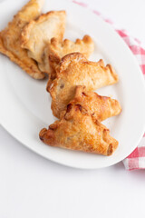 Triangular cookies with poppy seeds and powdered sugar.
