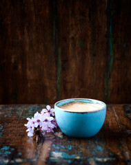 Cappuccino on dark wooden background. Copy space.