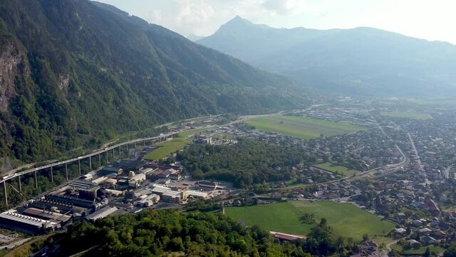 Aerial pan left from a polluted valley to a highway in the mountains. Vall&eacute;e de l'Arve, French Alps.