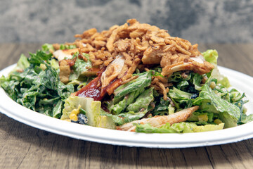 BBQ chicken salad piled high with romaine, chicken breast, lettuce, and dressing to fill any appetite.