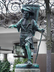 Sculpture of winemaker as a part of fountain on Weinplatz square in Zurich, Switzerland