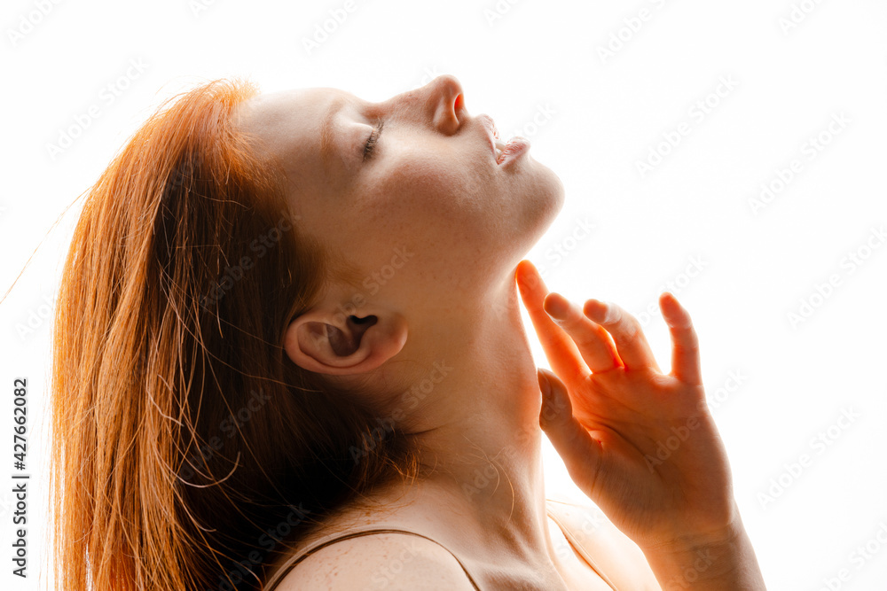 Wall mural young european ginger woman posing with eyes closed