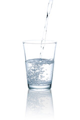 Pour drinking water into a clear glass.with Clipping Path.