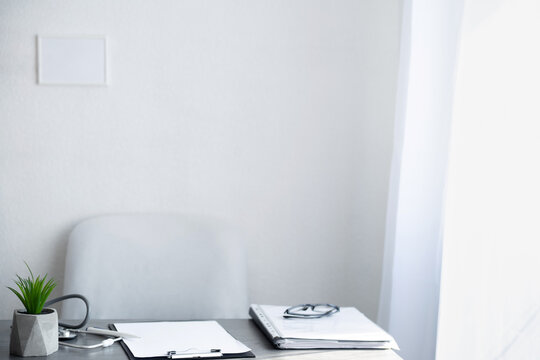 Empty doctor workplace, hospital office on light background, doctor desk