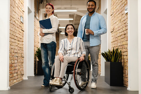 Multiracial Young Three Colleagues Smiling While Standing In Office