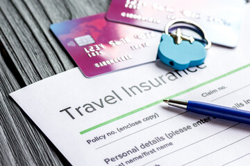 Travel preparation concept with insurance and cards on wooden table