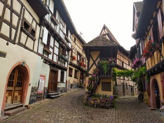 The picturesque streets of Eguisheim, Alsace. Central square with the fountain in Eguisheim. France. 