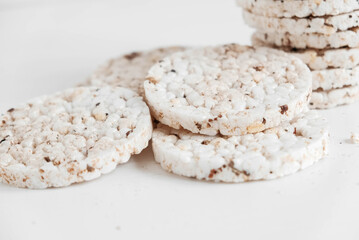 Round diet crispbreads on a white background. Round shaped cereal bread, healthy food without yeast. Copy, empty space for text