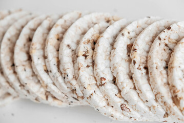Fototapeta na wymiar Round diet crispbreads on a white background. Round shaped cereal bread, healthy food without yeast. Top view. Copy, empty space for text