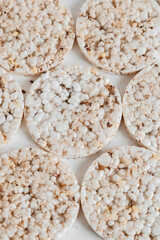 Round diet crispbreads on a white background. Round shaped cereal bread, healthy food without yeast. Top view. Copy, empty space for text