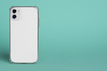 White iPhone 11 in clear silicone case back view. iPhone 12 case mockup isolated on green background. Banner with place for text on the right