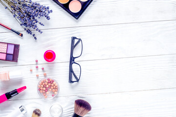 glasses and cosmetics on white woman table background top view