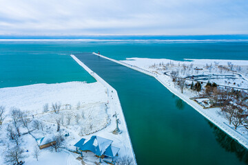 Icy Great Lakes Lighthouse and Pier at St. Joseph, Michigan Aerial View. Beautiful Lake Michigan Water views. 