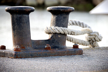 large ship iron mooring with white rope