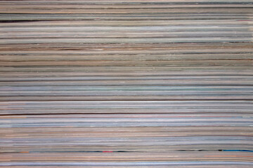 Background, texture of a stack of magazines.