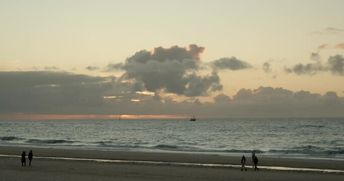 Time Lapse of the sunset on the beach of Sylt with boats on the sea