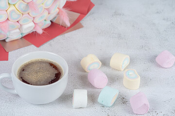 a cup of coffee on the background of sweets Marshmallows, close-up.Holiday concept, congratulations.